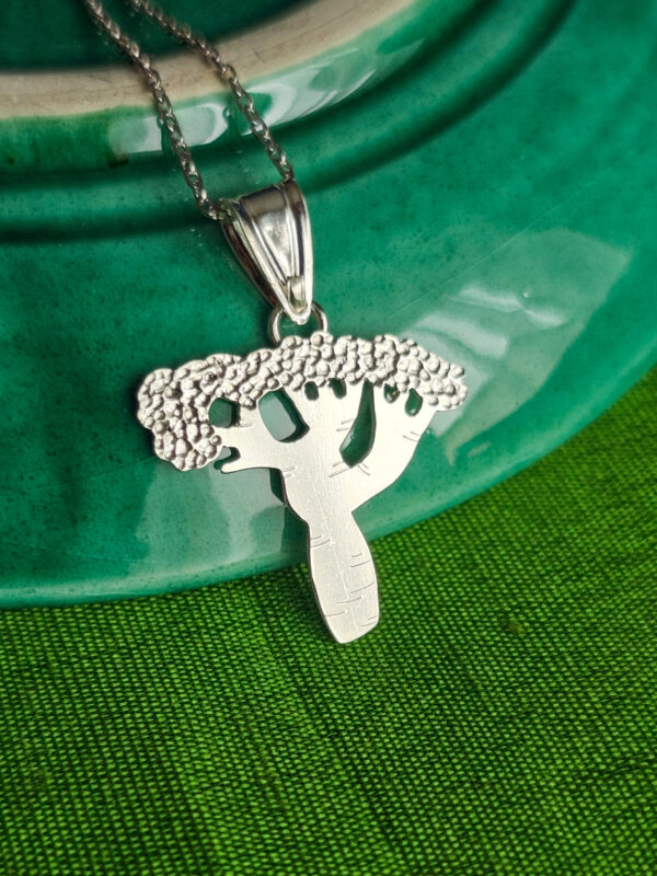 Collier Mbuyu en argent sur fond vert